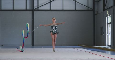 Young Gymnast Practicing Ribbon Routine in Sports Hall - Download Free Stock Images Pikwizard.com
