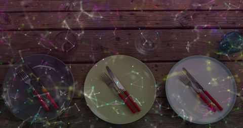 Interconnected Dining Setting with Network Overlay on Rustic Table