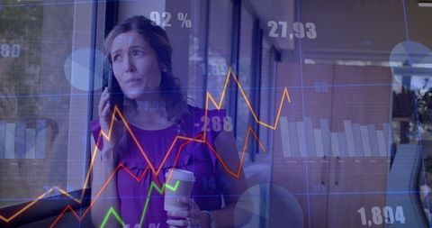 Businesswoman Overseeing Financial Data Projections in Office