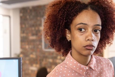 Pensive African American Woman in Modern Office Environment