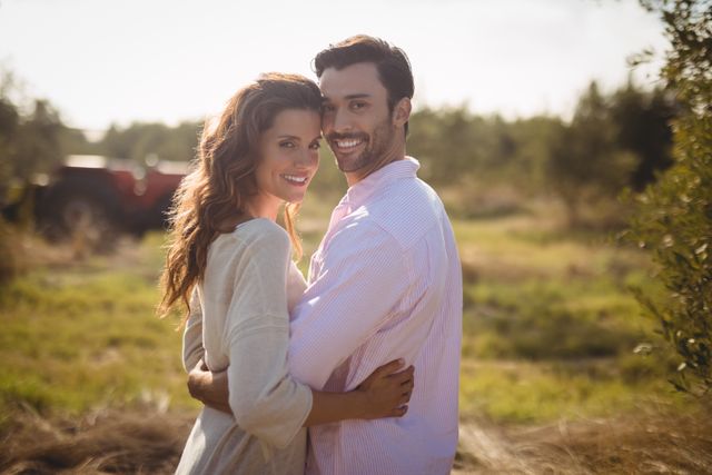 Portrait of smiling young couple embracing at olive farm - Download Free Stock Photos Pikwizard.com