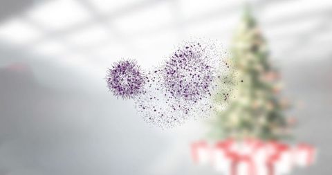 Floating luminous particle spheres with christmas tree in large room