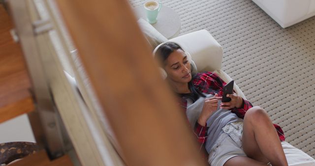 Young Woman Relaxing on Couch and Using Smartphone - Download Free Stock Images Pikwizard.com