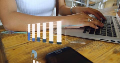 Businesswoman analyzing data on laptop with digital interface
