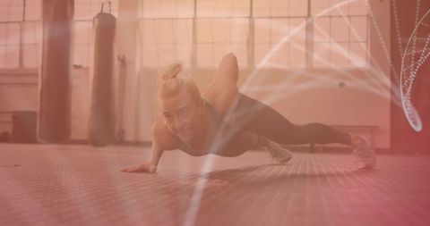 Determined Woman Performing One-Arm Push-Up in Gym Setting