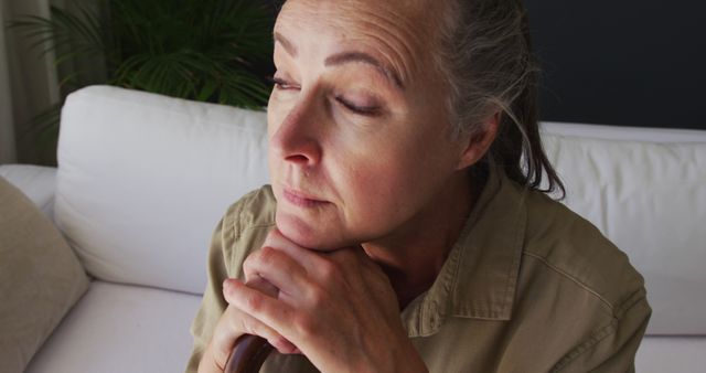 Pensive Senior Woman Resting on Couch - Download Free Stock Images Pikwizard.com