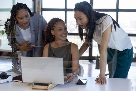 Diverse Women Innovating with Technology in Modern Office