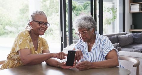 Elderly Friends Enjoying Smartphone Technology Together