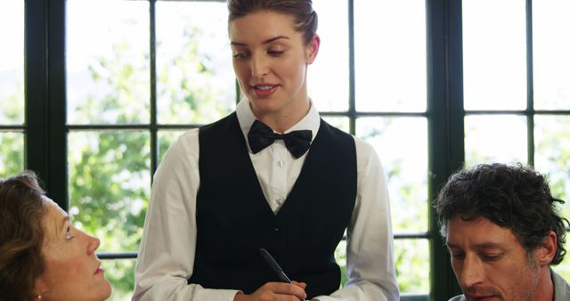 Female Waitress Taking Order From Restaurant Customers - Download Free Stock Images Pikwizard.com