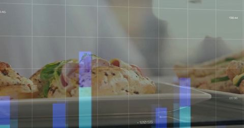Gourmet bagel sandwich on white plate with business data overlay and chef coat background