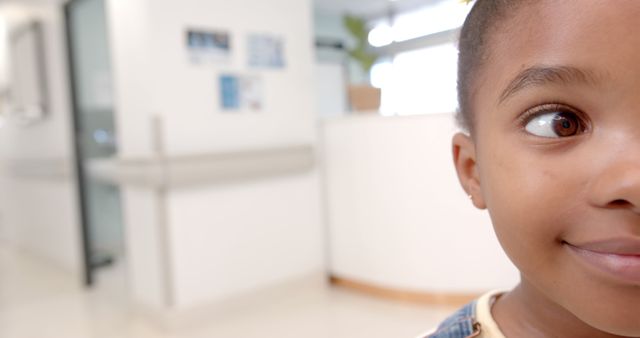 Close-Up of Smiling Child in Bright Hospital Corridor - Download Free Stock Images Pikwizard.com