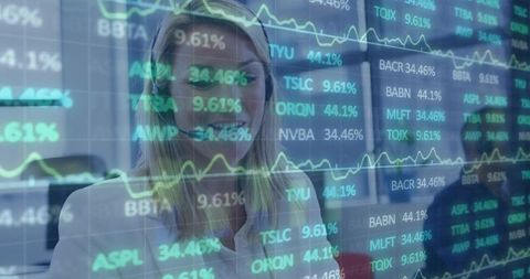 Mature female analyst studying stock tickers with translucent market data overlay