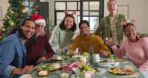 Diverse Friends Celebrating Holiday Meal Together with Joy