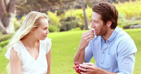Young Couple Enjoying Picnic with Grapes Outdoors - Download Free Stock Images Pikwizard.com