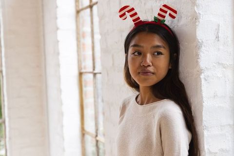Asian woman with candy cane headband in loft
