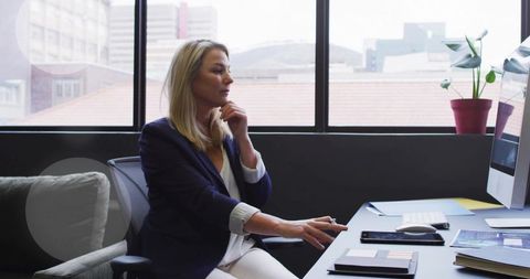 Business Professional in Modern Office Working Intently on Computer