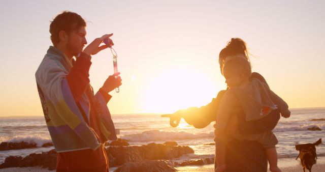 Young Family Enjoying Sunset at Beach - Download Free Stock Images Pikwizard.com