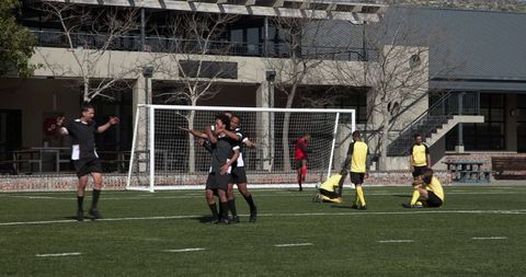 Teen Soccer Players Chasing Ball on School Sports Field