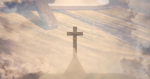 Rustic altar cross silhouette overlaid with golden sunlight and dreamy cloudscape