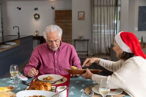 Senior Couple Sharing Festive Meal in Cozy Kitchen