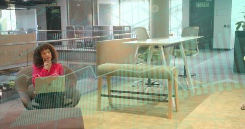 Businesswoman analyzing statistical data in modern office lounge