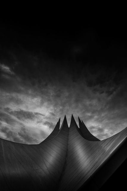 Greyscale Lowangle Photo of Pointed Structure Under Cloudy Sky - Download Free Stock Photos Pikwizard.com