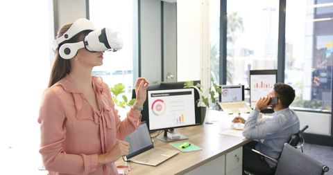 Young Woman Using VR Headset in Modern Office Environment