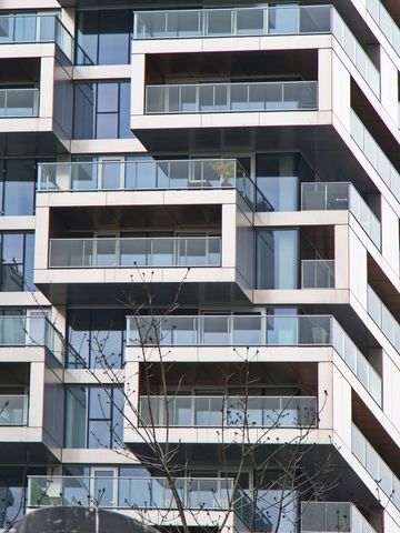 Modern geometric residential condo building with glass balconies
