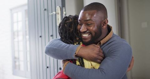 Smiling Father Hugging Daughter Before School