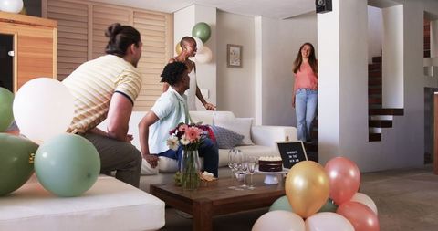 Friends Decorating Living Room with Cake and Balloons for Celebration