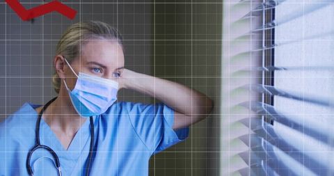 Nurse in Blue Scrubs Wearing Mask Looking Through Blinds