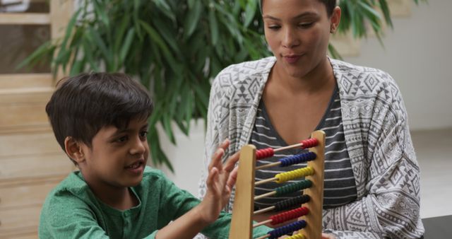 Mother and son playing with abacus, enjoying educational activity - Download Free Stock Images Pikwizard.com