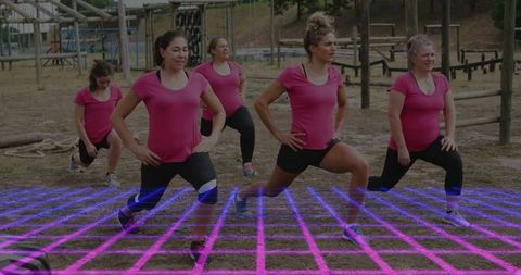 Five women performing lunges at outdoor fitness course