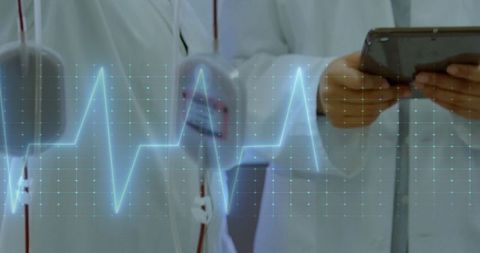 Doctors Using Tablets to Monitor Infusion Pumps in Hospital