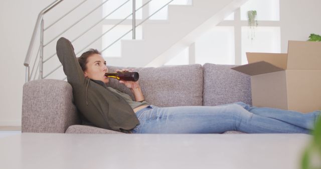 Young Woman Relaxing on Couch After Moving - Download Free Stock Images Pikwizard.com