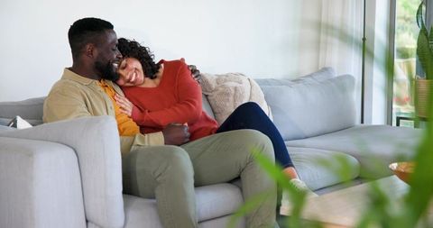 Couple Relaxing on Sofa in Bright Modern Living Room