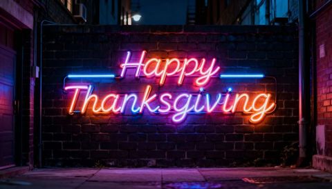 Neon happy thanksgiving sign lighting urban alley with colorful orange pink blue glow