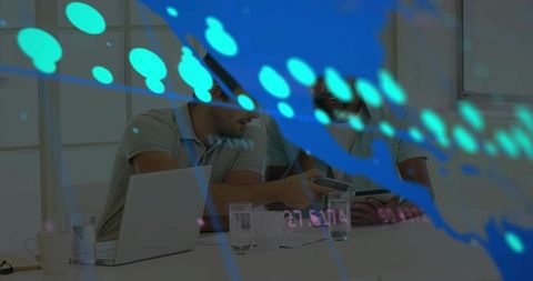 Collaborative team reviewing tablet with analytics overlay in modern boardroom