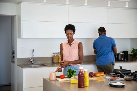 Diverse Couple Prepping Food Together in Modern Kitchen Setup