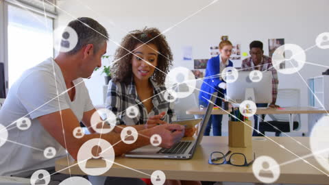 Diverse Business Team Sharing Digital Ideas in Modern Office