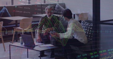 Business Partners Analyzing Stock Data in Modern Office Environment