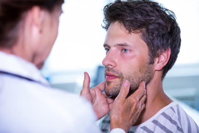 Doctor examining male patient in hospital. Useful for healthcare, medical, and wellness content. Ideal for illustrating doctor-patient interactions, medical checkups, and healthcare services.