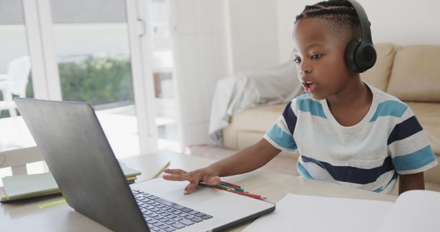 Young African American Boy Learning Online at Home with Laptop and Headphones - Download Free Stock Images Pikwizard.com