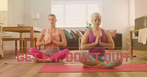 Diverse Female Couple Practicing Yoga at Home with Inspirational Message