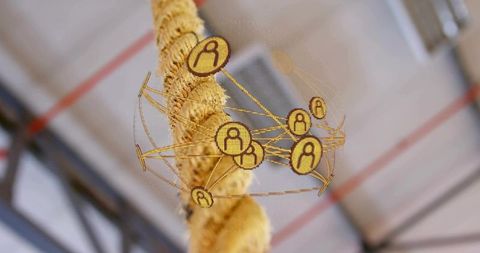 Hanging braided tan rope showing holographic golden network sphere with industrial beams and red pip