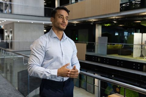 Confident Businessman in Modern Office Atrium