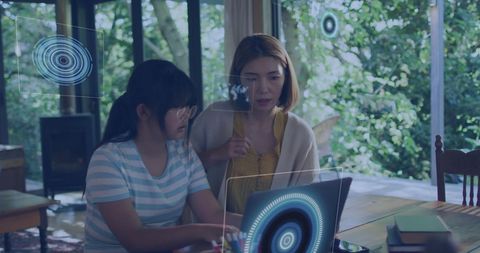 Asian Mother and Daughter Exploring Futuristic Technology
