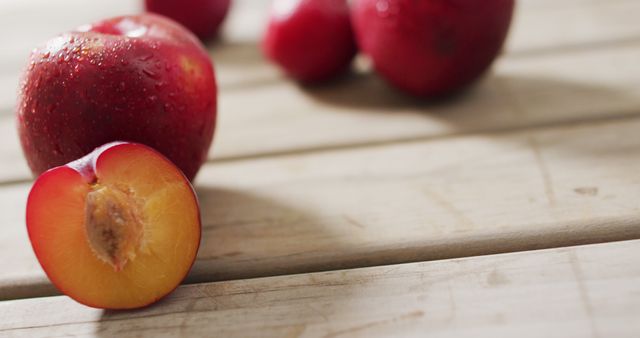 Fresh Red Plums on Wooden Table Surface - Download Free Stock Images Pikwizard.com