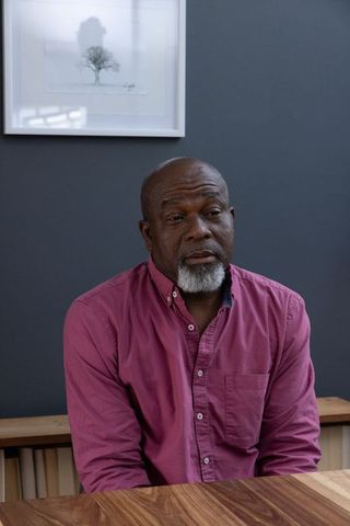 Elderly man in reflection at vintage studio table