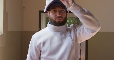Caucasian Male Fencer Preparing in Gym
